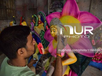 An artist paints an idol of the Hindu Goddess Laxmi at his workshop ahead of the Laxmi Puja in Nagaon District, Assam, India, on October 15,...