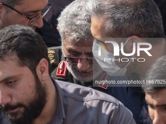 Brigadier General Esmail Qaani, Commander of the Quds Force of the Islamic Revolutionary Guard Corps, is escorted by unidentified men after...