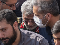 Brigadier General Esmail Qaani, Commander of the Quds Force of the Islamic Revolutionary Guard Corps, is escorted by unidentified men after...