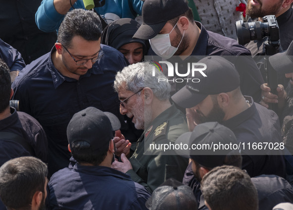 Brigadier General Esmail Qaani, Commander of the Quds Force of the Islamic Revolutionary Guard Corps, is escorted by unidentified men after...