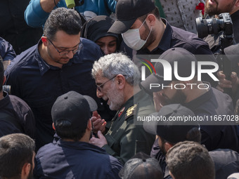 Brigadier General Esmail Qaani, Commander of the Quds Force of the Islamic Revolutionary Guard Corps, is escorted by unidentified men after...