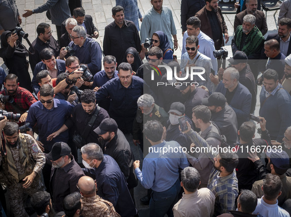 Brigadier General Esmail Qaani, Commander of the Quds Force of the Islamic Revolutionary Guard Corps, is escorted by unidentified men after...