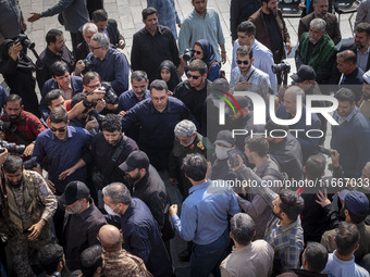 Brigadier General Esmail Qaani, Commander of the Quds Force of the Islamic Revolutionary Guard Corps, is escorted by unidentified men after...