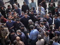 Brigadier General Esmail Qaani, Commander of the Quds Force of the Islamic Revolutionary Guard Corps, is escorted by unidentified men after...