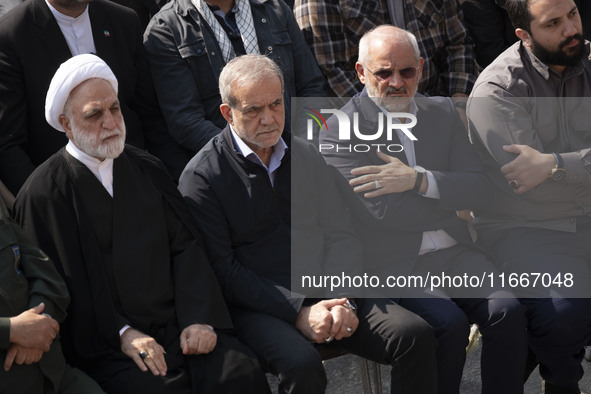 Iranian President Masoud Pezeshkian (second from left) attends a funeral ceremony for General Abbas Nilforoushan, a commander of the IRGC's...