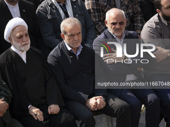 Iranian President Masoud Pezeshkian (second from left) attends a funeral ceremony for General Abbas Nilforoushan, a commander of the IRGC's...