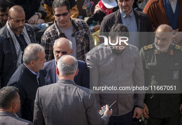 Iranian President Masoud Pezeshkian speaks with Hossein Salami, commander-in-chief of the Islamic Revolutionary Guard Corps (IRGC), after at...