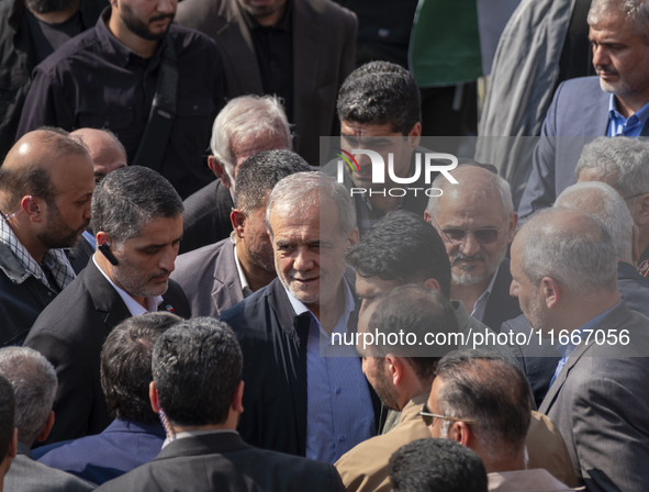 Iranian President Masoud Pezeshkian is escorted by his bodyguards after attending a funeral ceremony for General Abbas Nilforoushan, a comma...