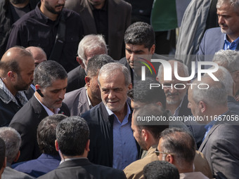 Iranian President Masoud Pezeshkian is escorted by his bodyguards after attending a funeral ceremony for General Abbas Nilforoushan, a comma...