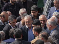 Iranian President Masoud Pezeshkian is escorted by his bodyguards after attending a funeral ceremony for General Abbas Nilforoushan, a comma...