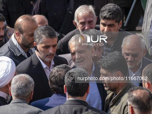 Iranian President Masoud Pezeshkian is escorted by his bodyguards after attending a funeral ceremony for General Abbas Nilforoushan, a comma...