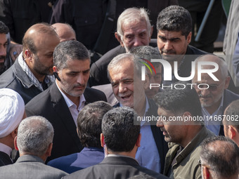 Iranian President Masoud Pezeshkian is escorted by his bodyguards after attending a funeral ceremony for General Abbas Nilforoushan, a comma...