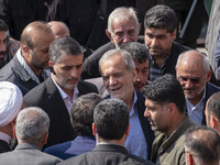 Iranian President Masoud Pezeshkian is escorted by his bodyguards after attending a funeral ceremony for General Abbas Nilforoushan, a comma...