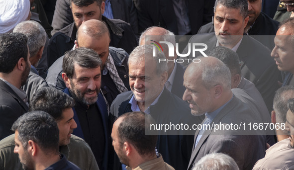 Iranian President Masoud Pezeshkian is escorted by his bodyguards after attending a funeral ceremony for General Abbas Nilforoushan, a comma...