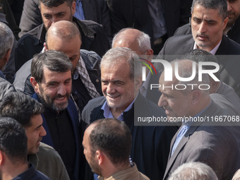 Iranian President Masoud Pezeshkian is escorted by his bodyguards after attending a funeral ceremony for General Abbas Nilforoushan, a comma...