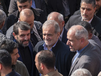 Iranian President Masoud Pezeshkian is escorted by his bodyguards after attending a funeral ceremony for General Abbas Nilforoushan, a comma...