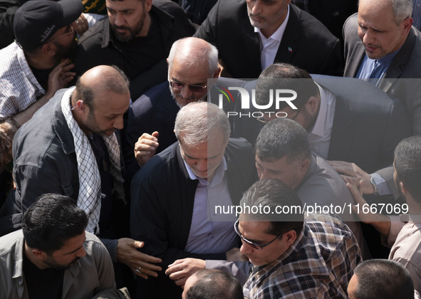 Iranian President Masoud Pezeshkian is escorted by his bodyguards after attending a funeral ceremony for General Abbas Nilforoushan, a comma...