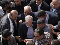 Iranian President Masoud Pezeshkian is escorted by his bodyguards after attending a funeral ceremony for General Abbas Nilforoushan, a comma...