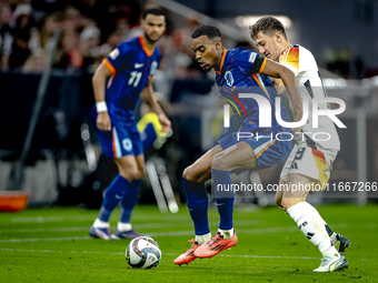 Netherlands midfielder Ryan Gravenberch and Germany midfielder Angelo Stiller play during the match between Germany and the Netherlands at t...