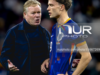 Netherlands trainer Ronald Koeman and Netherlands midfielder Mats Wieffer participate during the match between Germany and the Netherlands a...