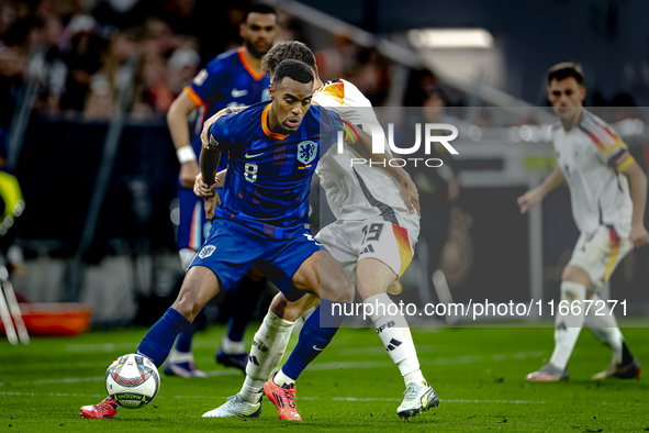 Netherlands midfielder Ryan Gravenberch and Germany midfielder Angelo Stiller play during the match between Germany and the Netherlands at t...