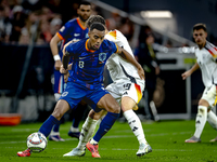 Netherlands midfielder Ryan Gravenberch and Germany midfielder Angelo Stiller play during the match between Germany and the Netherlands at t...