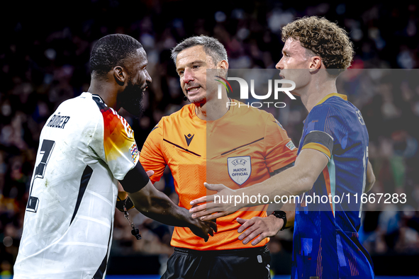 Referee Slavko Vincic, Germany defender Antonio Rudiger, and Netherlands midfielder Mats Wieffer are present during the match between German...