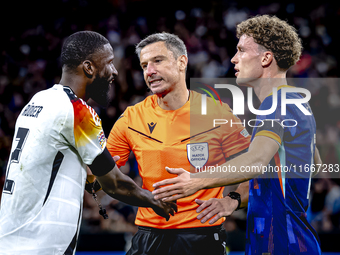 Referee Slavko Vincic, Germany defender Antonio Rudiger, and Netherlands midfielder Mats Wieffer are present during the match between German...