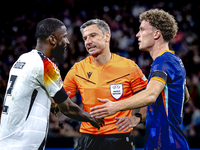 Referee Slavko Vincic, Germany defender Antonio Rudiger, and Netherlands midfielder Mats Wieffer are present during the match between German...