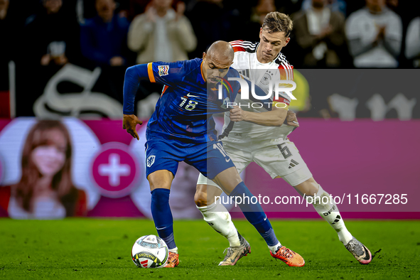 Netherlands forward Donyell Malen and Germany defender Joshua Kimmich play during the match between Germany and the Netherlands at the Allia...