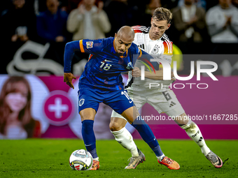 Netherlands forward Donyell Malen and Germany defender Joshua Kimmich play during the match between Germany and the Netherlands at the Allia...