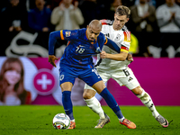 Netherlands forward Donyell Malen and Germany defender Joshua Kimmich play during the match between Germany and the Netherlands at the Allia...