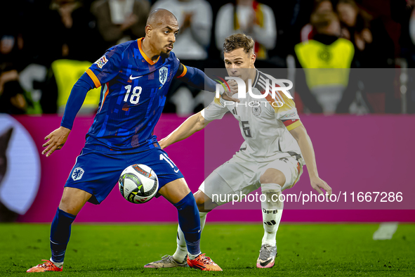 Netherlands forward Donyell Malen and Germany defender Joshua Kimmich play during the match between Germany and the Netherlands at the Allia...