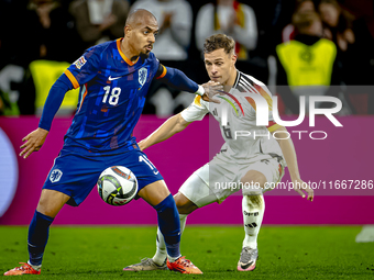 Netherlands forward Donyell Malen and Germany defender Joshua Kimmich play during the match between Germany and the Netherlands at the Allia...