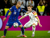 Netherlands forward Donyell Malen and Germany defender Joshua Kimmich play during the match between Germany and the Netherlands at the Allia...