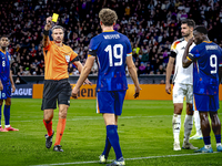 Referee Slavko Vincic gives Netherlands midfielder Mats Wieffer a yellow card during the match between Germany and the Netherlands at the Al...