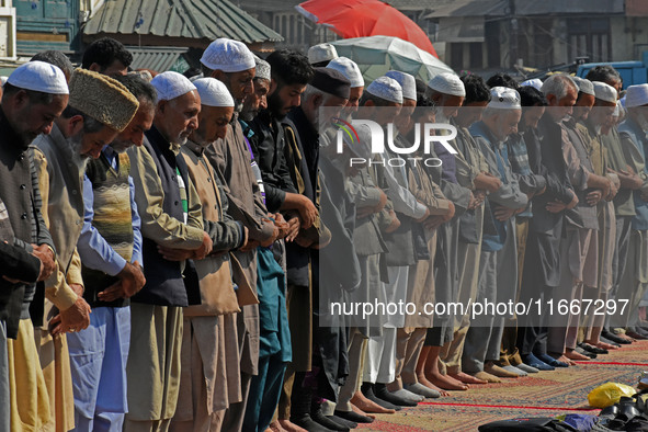 People offer congregational prayers during the annual festival of Saint Sheikh Abdul Qadir Jeelani (RA) in Srinagar, Kashmir, on October 15,...