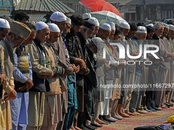 People offer congregational prayers during the annual festival of Saint Sheikh Abdul Qadir Jeelani (RA) in Srinagar, Kashmir, on October 15,...