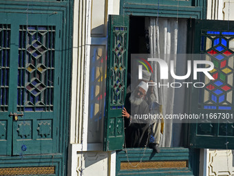 A devotee looks on as the head cleric (not in picture) displays the holy relic during the festival of Saint Sheikh Abdul Qadir Jeelani (RA)...