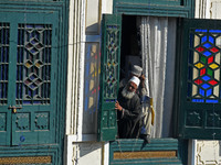 A devotee looks on as the head cleric (not in picture) displays the holy relic during the festival of Saint Sheikh Abdul Qadir Jeelani (RA)...