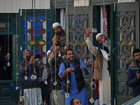 People pray as the head cleric (not in picture) displays the holy relic during the festival of Sufi Saint Sheikh Abdul Qadir Jeelani (RA) in...