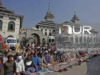 People offer congregational prayers during the annual festival of Saint Sheikh Abdul Qadir Jeelani (RA) in Srinagar, Kashmir, on October 15,...