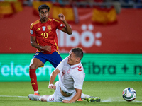 Lamine Yamal of Spain competes for the ball with Vestergaard of Denmark during the UEFA Nations League 2024/25 League A Group A4 game betwee...