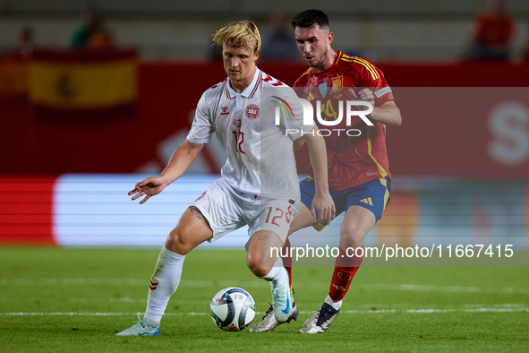 Dolberg of Denmark competes for the ball with Aymeric Laporte of Spain during the UEFA Nations League 2024/25 League A Group A4 game between...