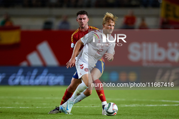 Dolberg (R) of Denmark competes for the ball with Aymeric Laporte of Spain during the UEFA Nations League 2024/25 League A Group A4 game bet...