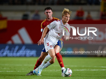 Dolberg (R) of Denmark competes for the ball with Aymeric Laporte of Spain during the UEFA Nations League 2024/25 League A Group A4 game bet...