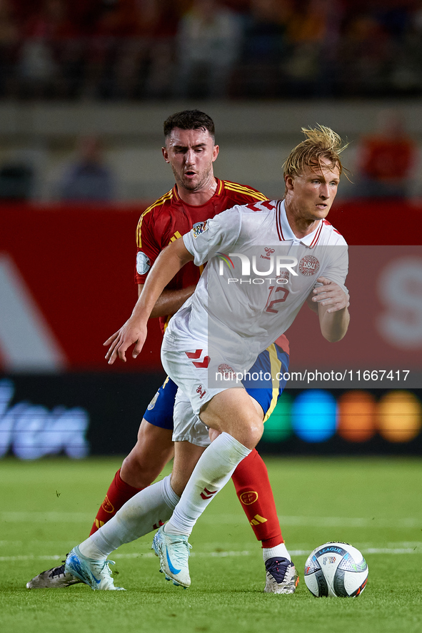 Dolberg (R) of Denmark competes for the ball with Aymeric Laporte of Spain during the UEFA Nations League 2024/25 League A Group A4 game bet...