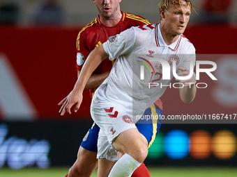 Dolberg (R) of Denmark competes for the ball with Aymeric Laporte of Spain during the UEFA Nations League 2024/25 League A Group A4 game bet...