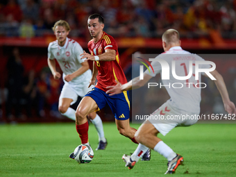 Fabian Ruiz of Spain competes for the ball with Rasmus Kristensen of Denmark during the UEFA Nations League 2024/25 League A Group A4 game b...