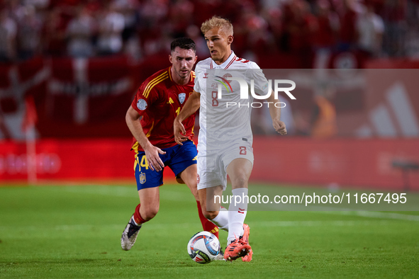 Isaksen of Denmark competes for the ball with Aymeric Laporte of Spain during the UEFA Nations League 2024/25 League A Group A4 game between...